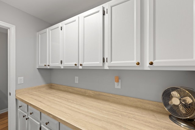 kitchen with light countertops and white cabinetry