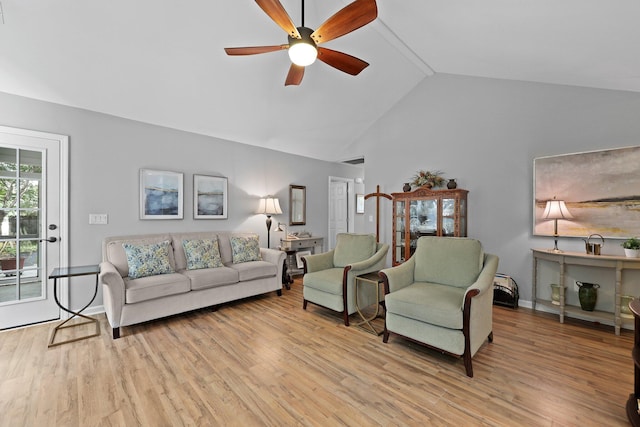 living area with ceiling fan, light wood finished floors, high vaulted ceiling, and baseboards