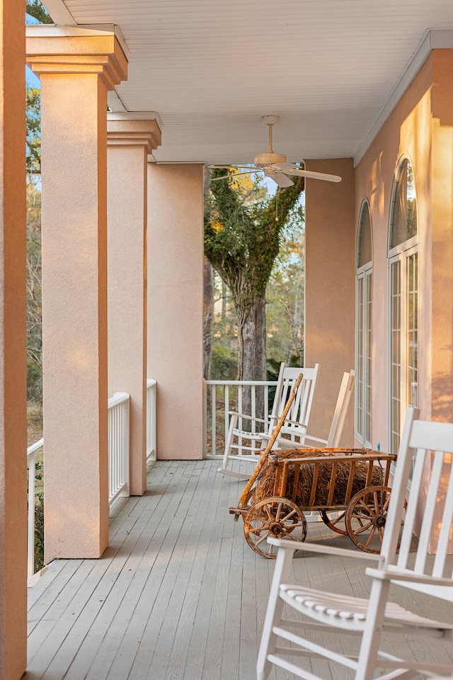 wooden deck featuring ceiling fan