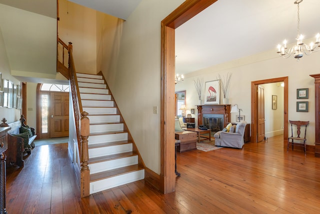 stairway featuring wood-type flooring and a chandelier