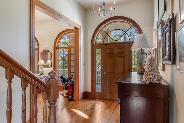 foyer featuring an inviting chandelier and light hardwood / wood-style flooring