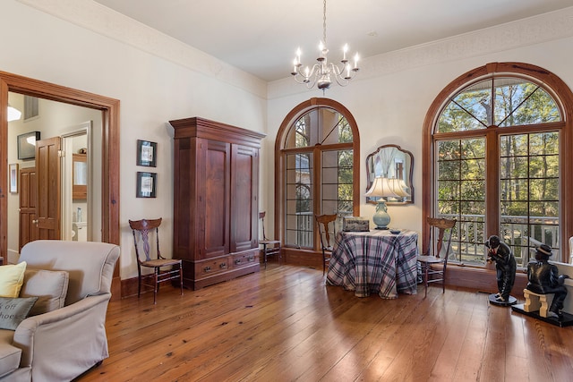 living area with an inviting chandelier and dark hardwood / wood-style flooring