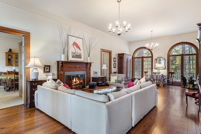 living room featuring a notable chandelier and dark hardwood / wood-style flooring