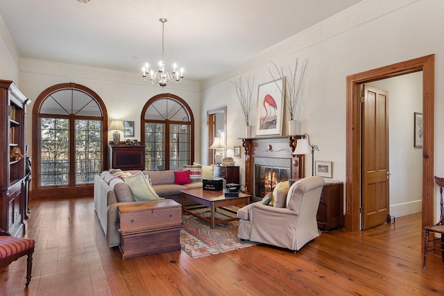 living room with an inviting chandelier, dark wood-type flooring, and french doors