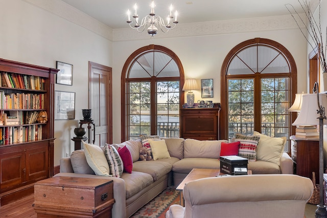 living room with a notable chandelier, a wealth of natural light, and dark hardwood / wood-style floors