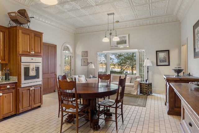 dining room with a chandelier and a towering ceiling