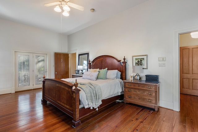 bedroom featuring access to outside, ceiling fan, a towering ceiling, and dark hardwood / wood-style flooring