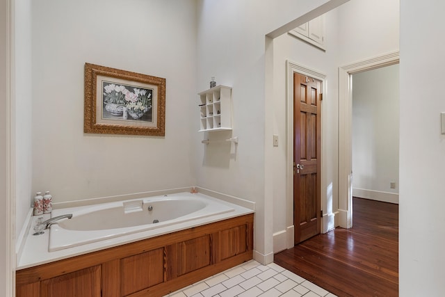 bathroom with a bathtub and hardwood / wood-style floors