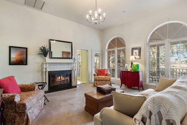 carpeted living room featuring an inviting chandelier