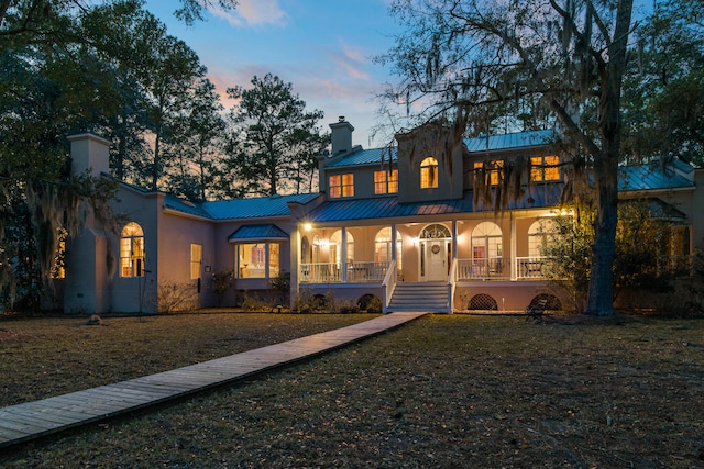 view of front of home featuring a yard and a porch