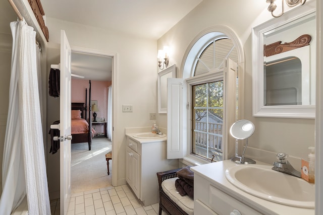 bathroom featuring tile floors and dual bowl vanity