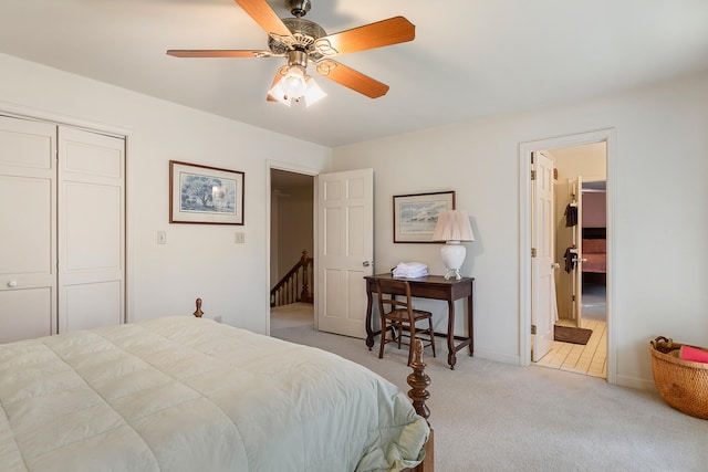 bedroom with light colored carpet, a closet, and ceiling fan