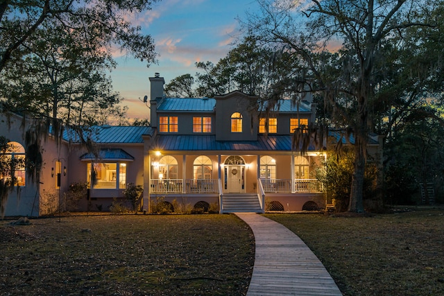 view of front of home featuring a porch and a yard