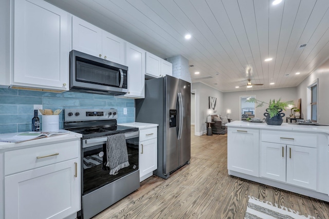 kitchen with wood ceiling, appliances with stainless steel finishes, backsplash, light hardwood / wood-style floors, and white cabinets