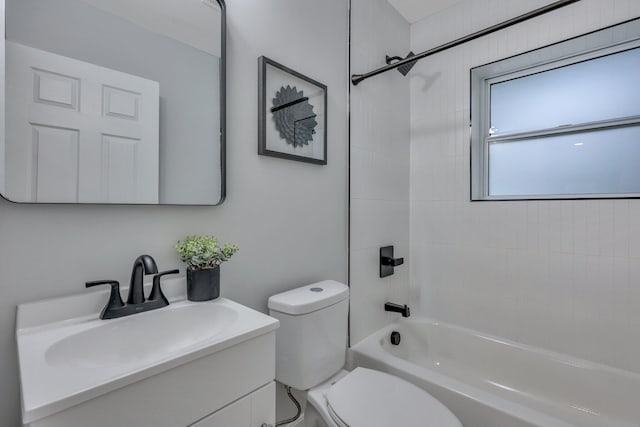 full bathroom with vanity, tiled shower / bath, and toilet