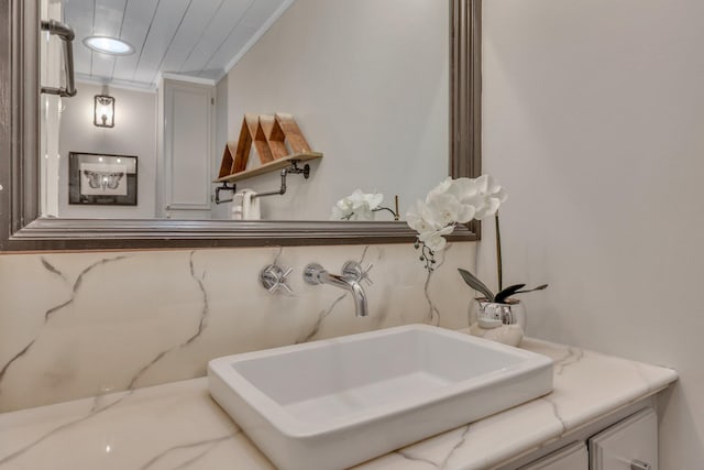 bathroom featuring vanity and crown molding