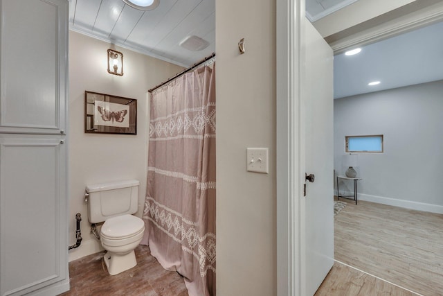 bathroom featuring ornamental molding, toilet, curtained shower, and wood-type flooring