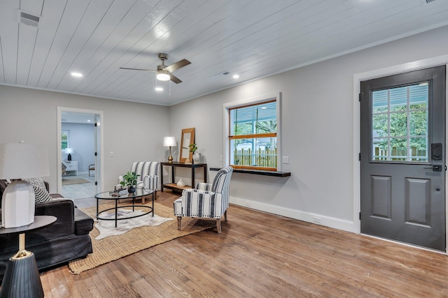 entryway with hardwood / wood-style floors, wood ceiling, ornamental molding, and ceiling fan