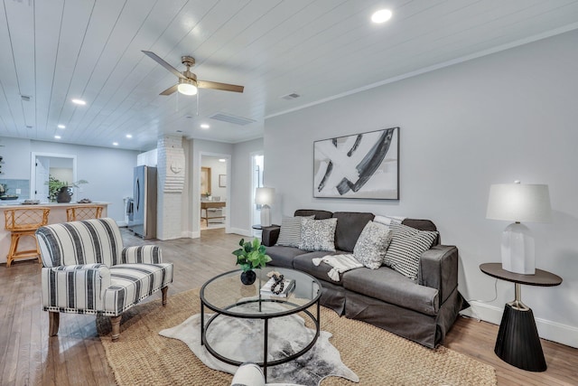 living room featuring ornamental molding, hardwood / wood-style floors, wooden ceiling, and ceiling fan