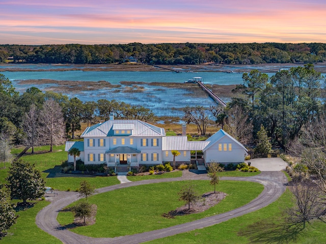 aerial view at dusk with a water view