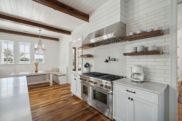 kitchen featuring white cabinetry, range with two ovens, dark hardwood / wood-style floors, and pendant lighting