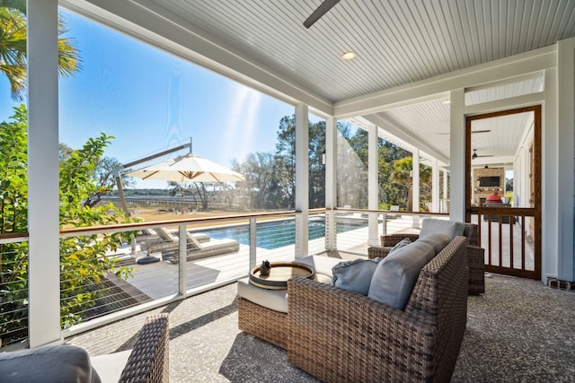 sunroom featuring ceiling fan