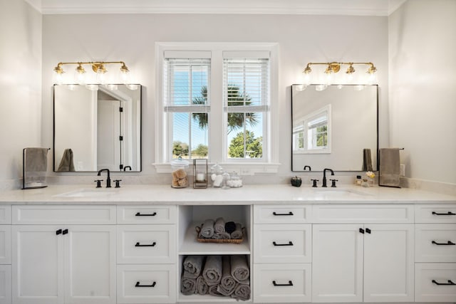 bathroom featuring ornamental molding, double sink vanity, and a wealth of natural light