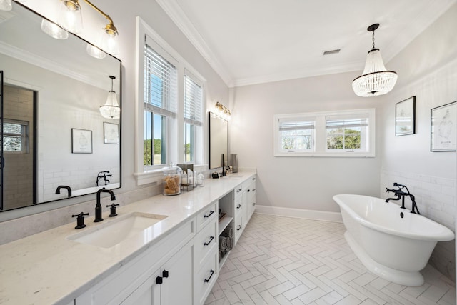 bathroom with plenty of natural light, ornamental molding, a washtub, and dual vanity