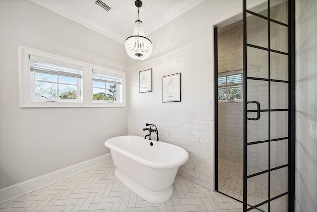 bathroom featuring an inviting chandelier, crown molding, tile floors, and plus walk in shower