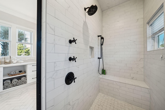 bathroom featuring ornamental molding and a tile shower