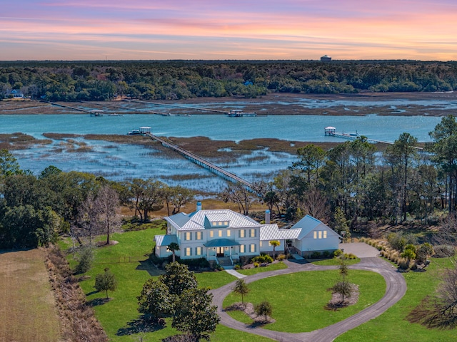 aerial view at dusk with a water view