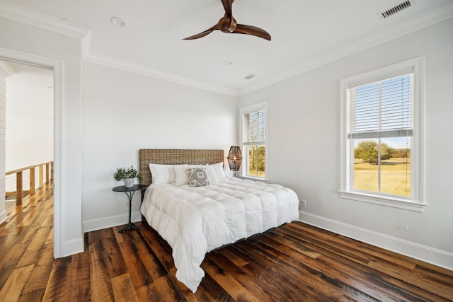 bedroom with ornamental molding, dark hardwood / wood-style flooring, ceiling fan, and multiple windows