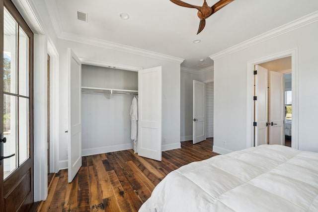 bedroom featuring crown molding, a closet, ceiling fan, and dark wood-type flooring