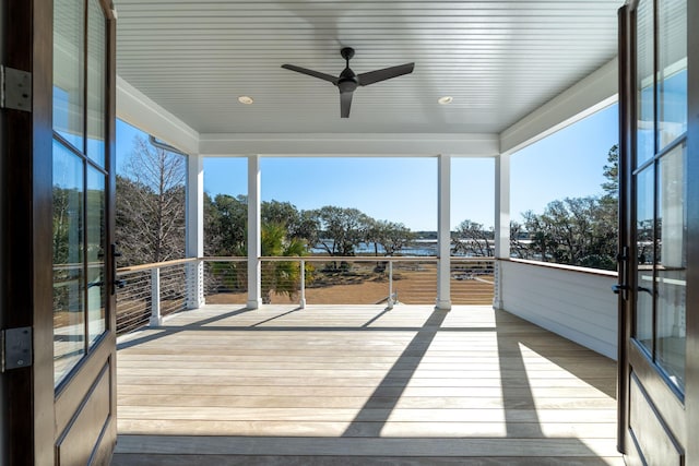 unfurnished sunroom featuring ceiling fan