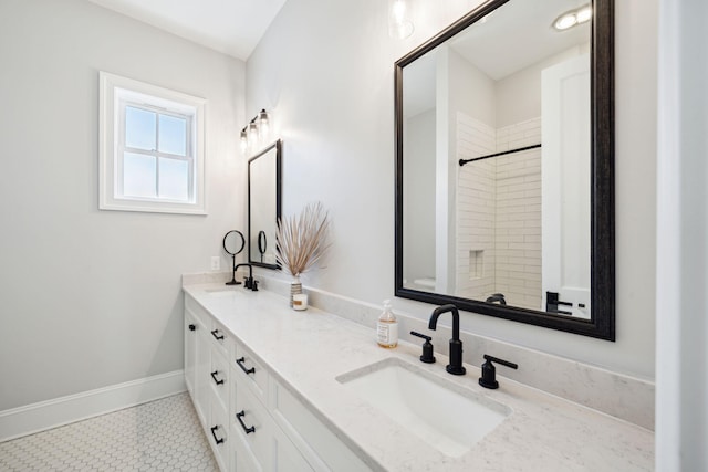 bathroom with oversized vanity, double sink, and tile flooring