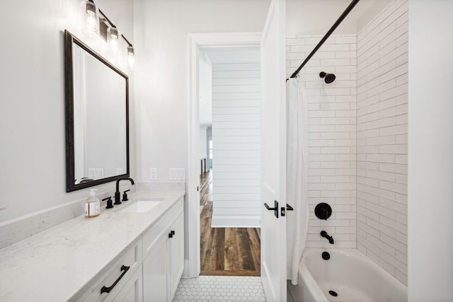 bathroom featuring hardwood / wood-style floors, shower / bath combo, and vanity with extensive cabinet space