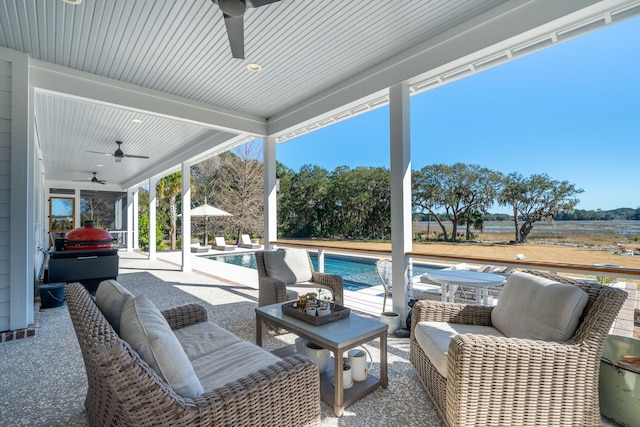 view of terrace with ceiling fan and an outdoor living space