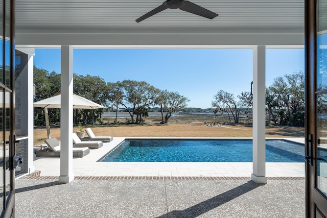 view of swimming pool featuring a patio and ceiling fan