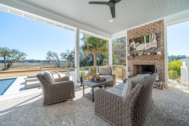 view of patio with ceiling fan and an outdoor living space with a fireplace