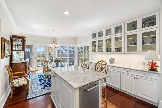 kitchen featuring dark hardwood / wood-style floors, decorative light fixtures, white cabinetry, and a chandelier