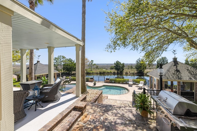 view of patio / terrace featuring area for grilling and a water view