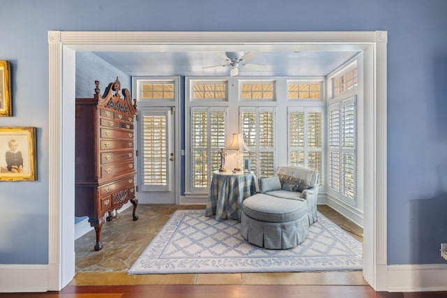 living area with ceiling fan and hardwood / wood-style flooring