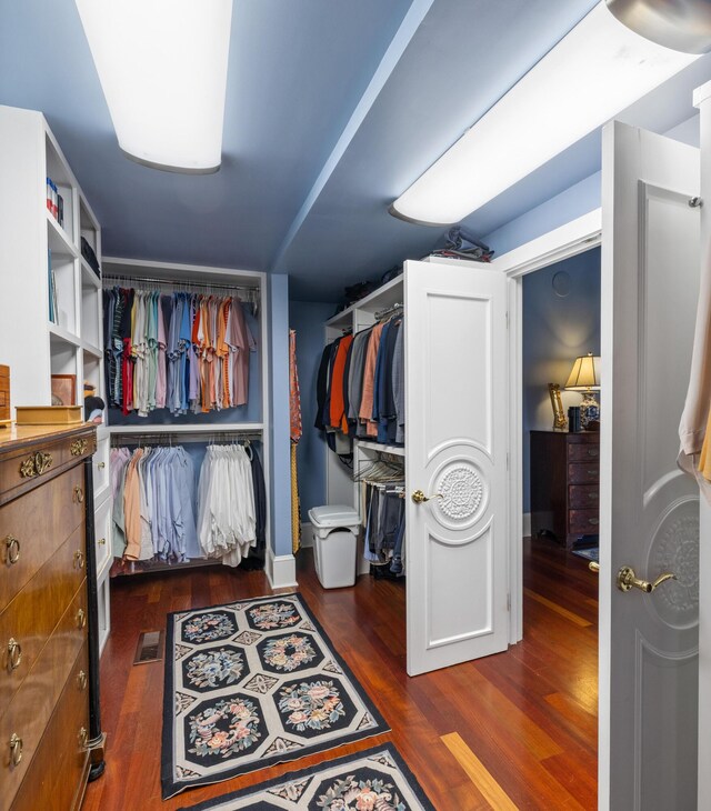 walk in closet featuring dark wood-type flooring