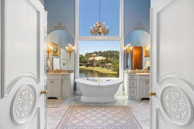 bathroom featuring tile floors, a bath, vanity, and an inviting chandelier