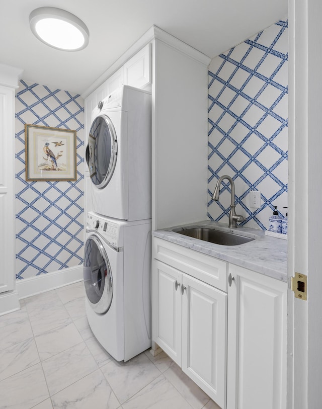 laundry room featuring cabinets, sink, light tile floors, and stacked washer / dryer