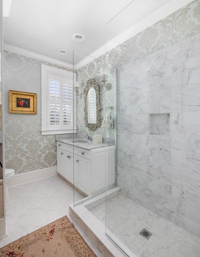 bathroom featuring toilet, a shower with door, vanity, crown molding, and tile floors