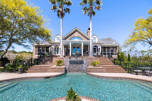 view of swimming pool featuring a patio area and a sunroom