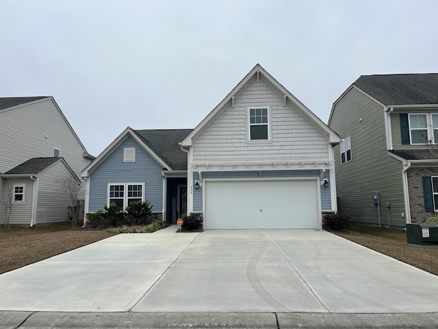 view of front of property with a garage and central AC unit