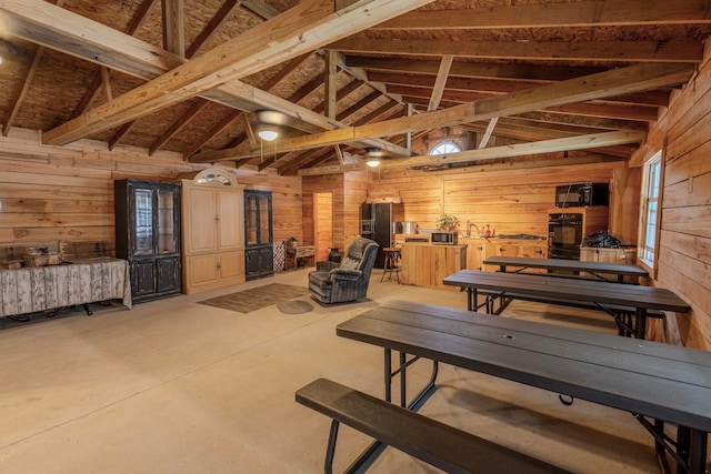 miscellaneous room featuring wooden walls and lofted ceiling