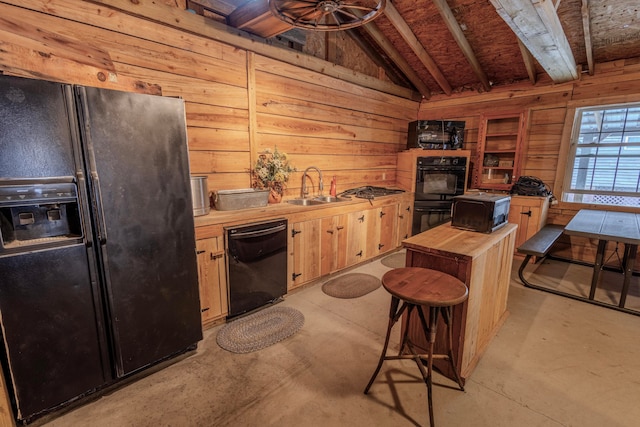 kitchen featuring a kitchen breakfast bar, vaulted ceiling, wooden counters, black appliances, and sink